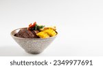 Beef Bowl. bowl of white rice topped with slices of grill beef. Japanese food on restaurant table. Isolate on white background