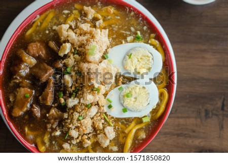 beef brisket in thick egg noodle soup or also known as beef pares lomi