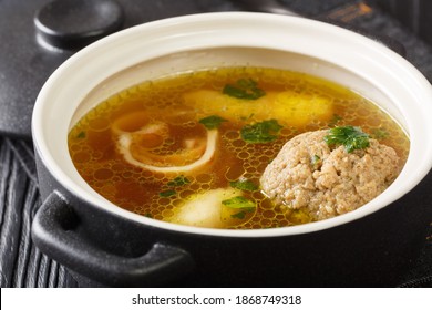 Beef Broth Or Rindsuppe Is The Most Popular Of Austria’s With Pancake Strips Frittaten, Semolina Dumplings, Liver Dumpling Close-up In A Saucepan On The Table. Horizontal
