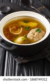 Beef Broth Rindsuppe With Pancake Strips Frittaten, Semolina Dumplings, Liver Dumpling Close-up In A Saucepan On The Table. Vertical
