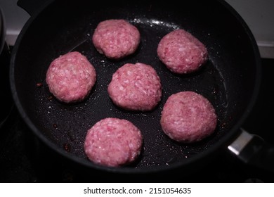 Beef burger patties sizzling on a hot pan. Cooking homemade round minced meat cutlets.