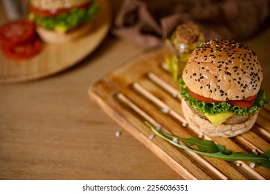 Beef burger with wooden tray on wooden tabletop. Homemade burger, American food, Junk food - Shutterstock ID 2256036351