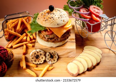 Beef Cheese burger with french fries, potato and tomato slice isolated on wooden board slide view on table fast food