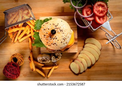 Beef Cheese burger with french fries, potato and tomato slice isolated on wooden board top view on table fast food
