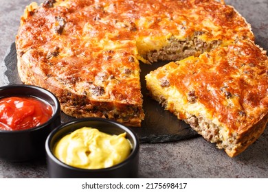 Beef Cheeseburger Pie Served With Sauces Close-up On A Slate Board On The Table. Horizontal
