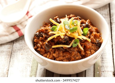 Beef Chili  / Bowl Of Beef Chili With Cheddar Cheese On Top