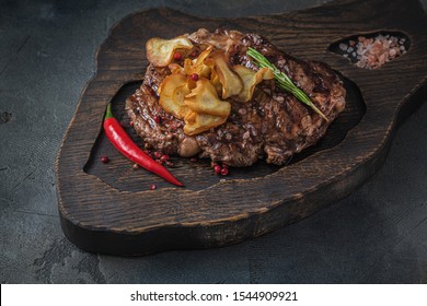 Beef Chuck Roll Steak On Wooden Board, Close View