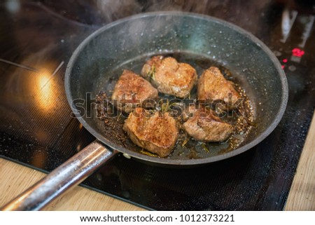 Beef cooked in frying pan