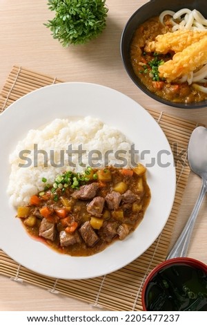 Beef curry with rice on wooden table, Japanese food.