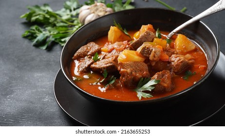 Beef goulash, soup and a stew, made of beef chuck steak, potatoes and plenty of paprika. Hungarian  traditional meal. - Shutterstock ID 2163655253