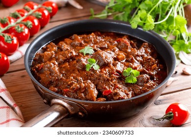 Beef goulash, soup and a stew, made of beef chuck steak plenty of paprika. Hungarian traditional meal. Beef stew - goulash