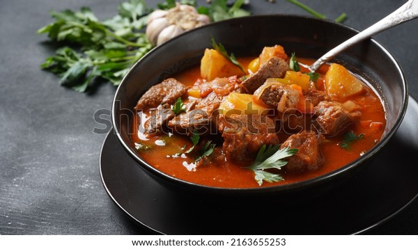 Beef\
goulash, soup and a stew, made of beef chuck steak, potatoes and\
plenty of paprika. Hungarian  traditional\
meal.