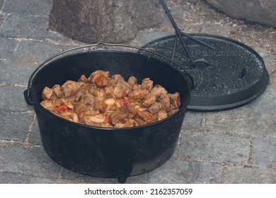 Beef Goulash With Vegetables In The Cast Iron Dutch Oven Pot.