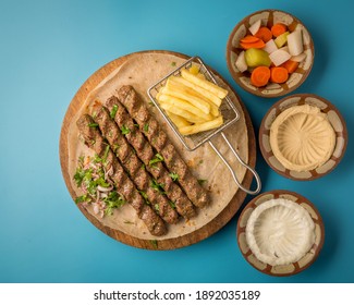 Beef Kebab Meal With Fried Chips And Humus And Garlic Sauce With Pickels