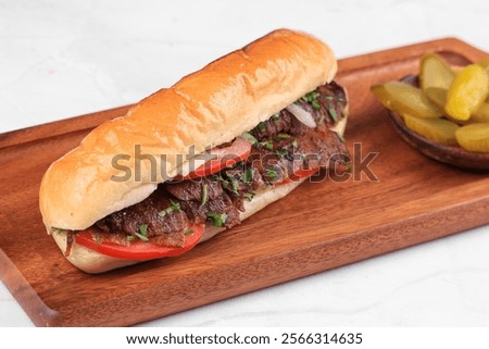Beef meat Shawarma Samoon Bread with tomato and garlic, and pickles, popular Middle Eastern dish , wooden bord 