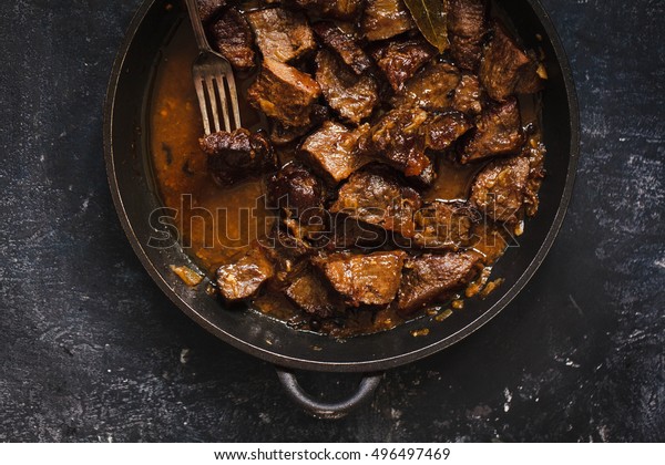 Beef meat stew. Overhead view braised beef meat stew\
with vegetables in pot.