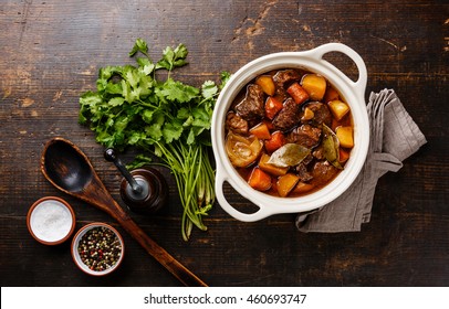 Beef meat stewed with potatoes, carrots and spices in ceramic pot - Shutterstock ID 460693747