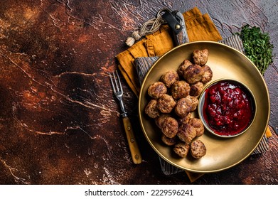 Beef meatballs with lingonberries jam, swedish meatballs. Dark background. Top view. Copy space.