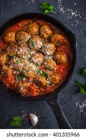 beef  meatballs with tomato sauce and parmesan cheese in pan, top view