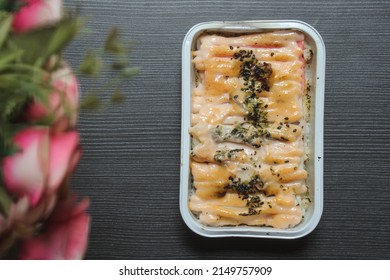 Beef mentaiko rice top view. Japanese beef mentai rice with smoked meat, seaweed, and mayonnaise. Served on aluminium foil - Shutterstock ID 2149757909