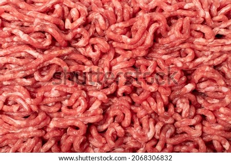 Beef mince meat texture background. Ground fresh veal fillet textured pattern, uncooked mincemeat, raw beef forcemeat, farce meat top view