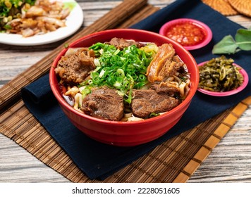 beef noodles with green onion and chili sauce served in a bowl isolated on table top view of taiwanese food - Powered by Shutterstock