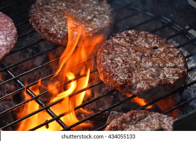 Beef or pork meat barbecue burgers for hamburger prepared grilled on bbq fire flame grill - Shutterstock ID 434055133
