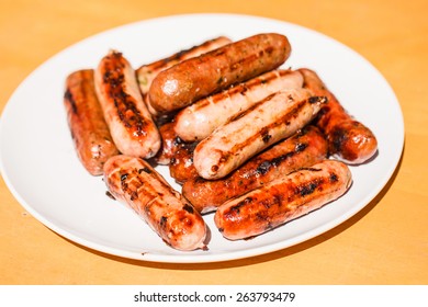 Beef and pork sausages on white plate
