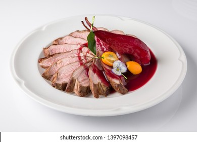 Beef or pork steak with drunk pear cooked in wine with cherry sauce, berries, citrus. Meat Calf or piglet. Banquet festive dishes. Fine dining restaurant menu. White background.  - Shutterstock ID 1397098457