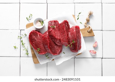 Beef. Raw beef tenderloin meat, beef steaks with ingredients for cooking. Top view - Powered by Shutterstock