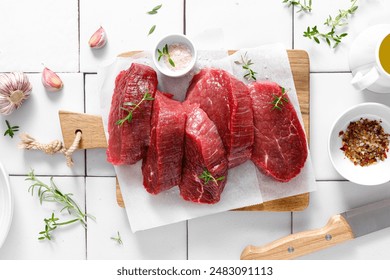 Beef. Raw beef tenderloin meat, beef steaks with ingredients for cooking. Top view - Powered by Shutterstock