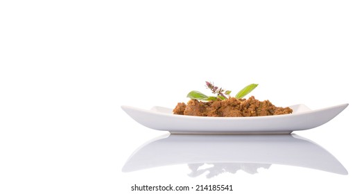 The Beef Rendang, a popular traditional Malay dish on white plate over white background