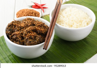 Beef Rendang & Sticky Rice - Malaysian/Indonesian spicy dry beef stew with coconut milk, topped with roasted dessicated coconut and served sticky rice.