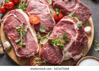 Beef ribe eye steaks with rosemary oregano and tomatoes. - Shutterstock ID 1621475668