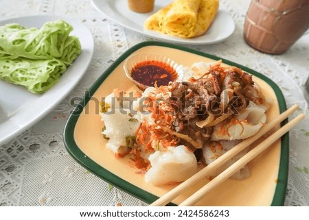 A beef rice noodle roll with chili oil, also known as a steamed rice roll and cheung fun. Ci Cong Fan. Eating steamed chinese dumpling dim sum. Authentic typical chinese food.