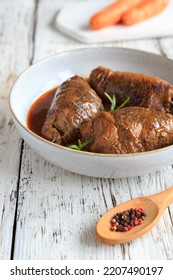beef rolls with sauce on a plate - Shutterstock ID 2207490197