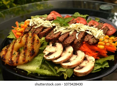 Beef Served With Grilled Pinapple, Mushrooms And Salad