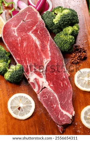 Beef shoulder blades triangular meat are placed on a wooden cutting board