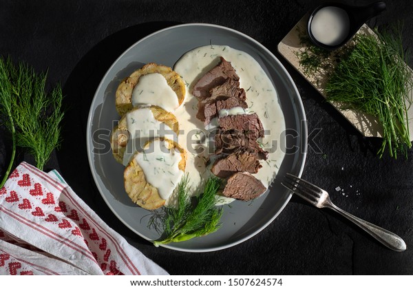 Beef slices\
with dill sauce and bread\
dumpling