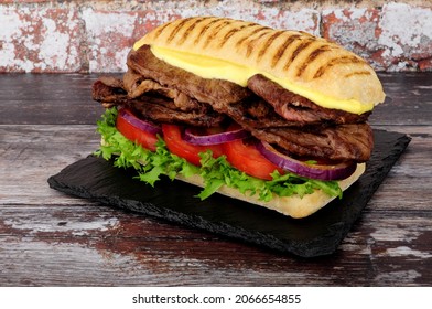 Beef Steak And Fresh Salad Filled Sandwich With Mayonnaise In A Soft Panini Bread Roll