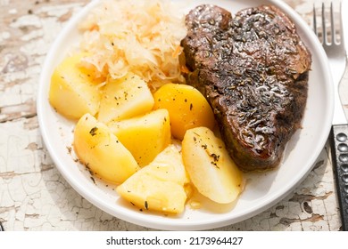 Beef Steak With Fried Potatoes And Cabbage And Carrot Slaw