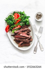 Beef Steak And Kale, Tomato Salad - Delicious Balanced Diet Lunch On A Light Background, Top View