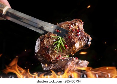 Beef Steak On Grill, Isolated On Black Background