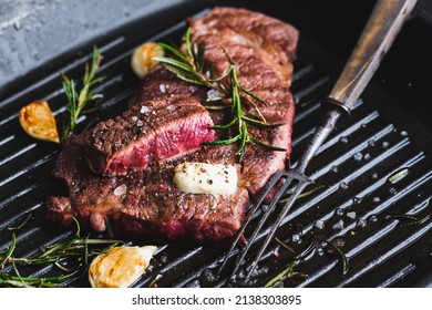 Beef Steak With Rosemary, Black Pepper, Sea Salt And Butter On A Grill Pan, Selective Focus