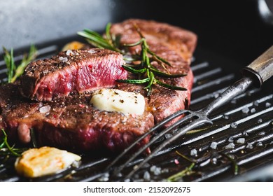 Beef Steak With Rosemary, Black Pepper, Sea Salt And Butter On A Grill Pan, Selective Focus