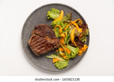 Beef Steak With Salad On A Plate. Top View