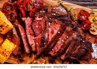 Beef Steaks With Grilled Tomatoes, Mushrooms And Corn, Top View.