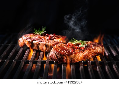 Beef steaks on the grill with flames - Shutterstock ID 413329057