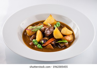 Beef Stew With Potatoes, Irish Stew Or Guinness Stew Made In A Crockpot Or Slow Cooker, Delicious Stew Estofado With Beef And Vegetables In A Bowl On A White Background