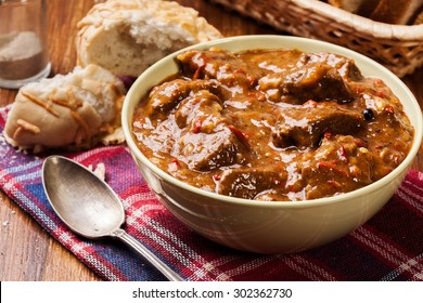Beef stew served with crusty bread in a bowl - Shutterstock ID 302362730